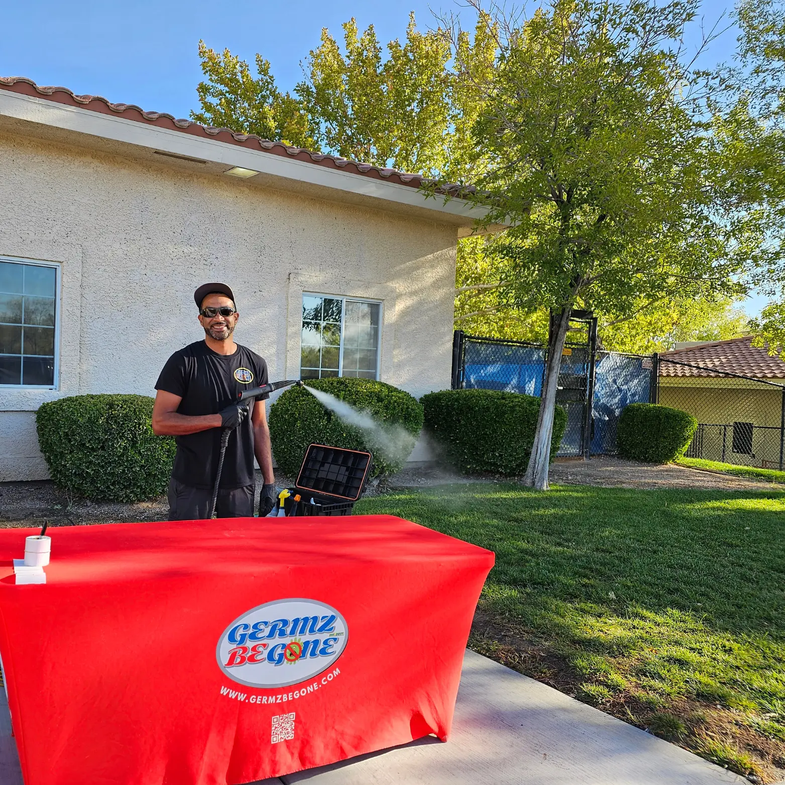 Professional technician cleaning baby gear outdoors using specialized equipment